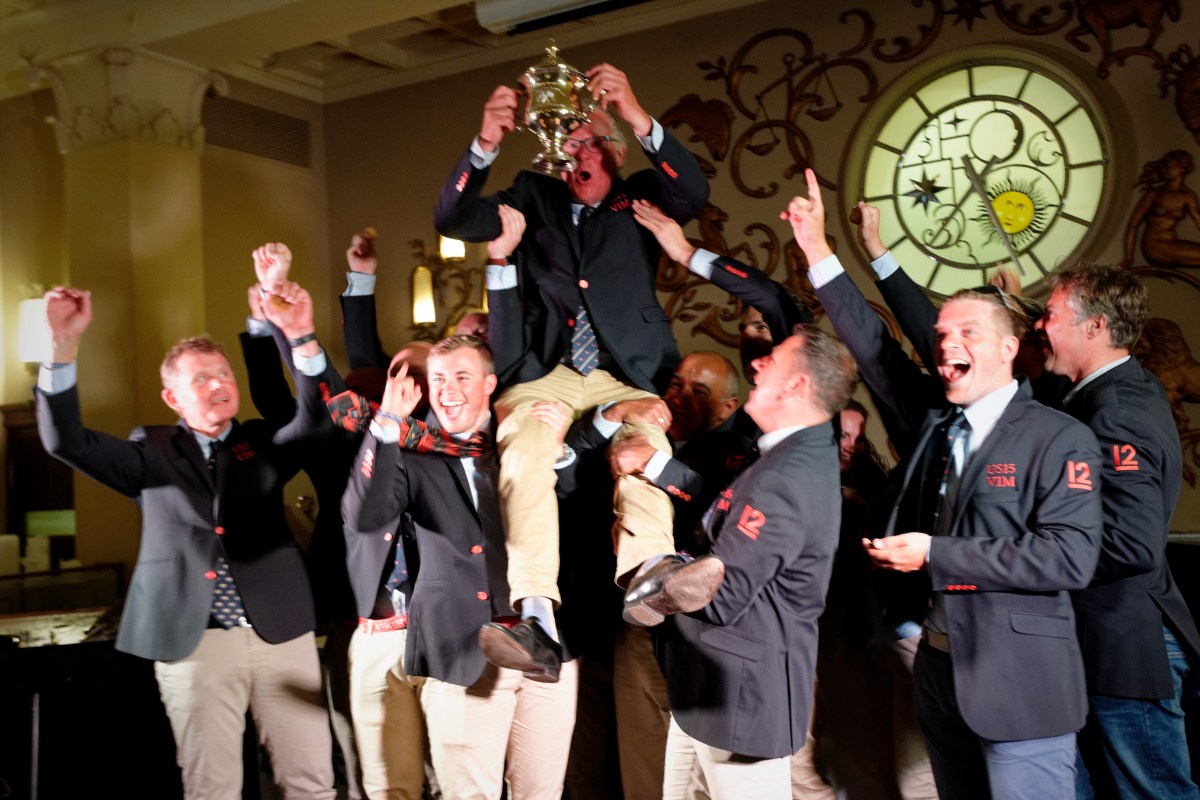 The jubilant VIM (US-15) crew hoists skipper Patrick Howaldt and the newly dedicated Vintage 12mR World Championship | Sailpix.FI